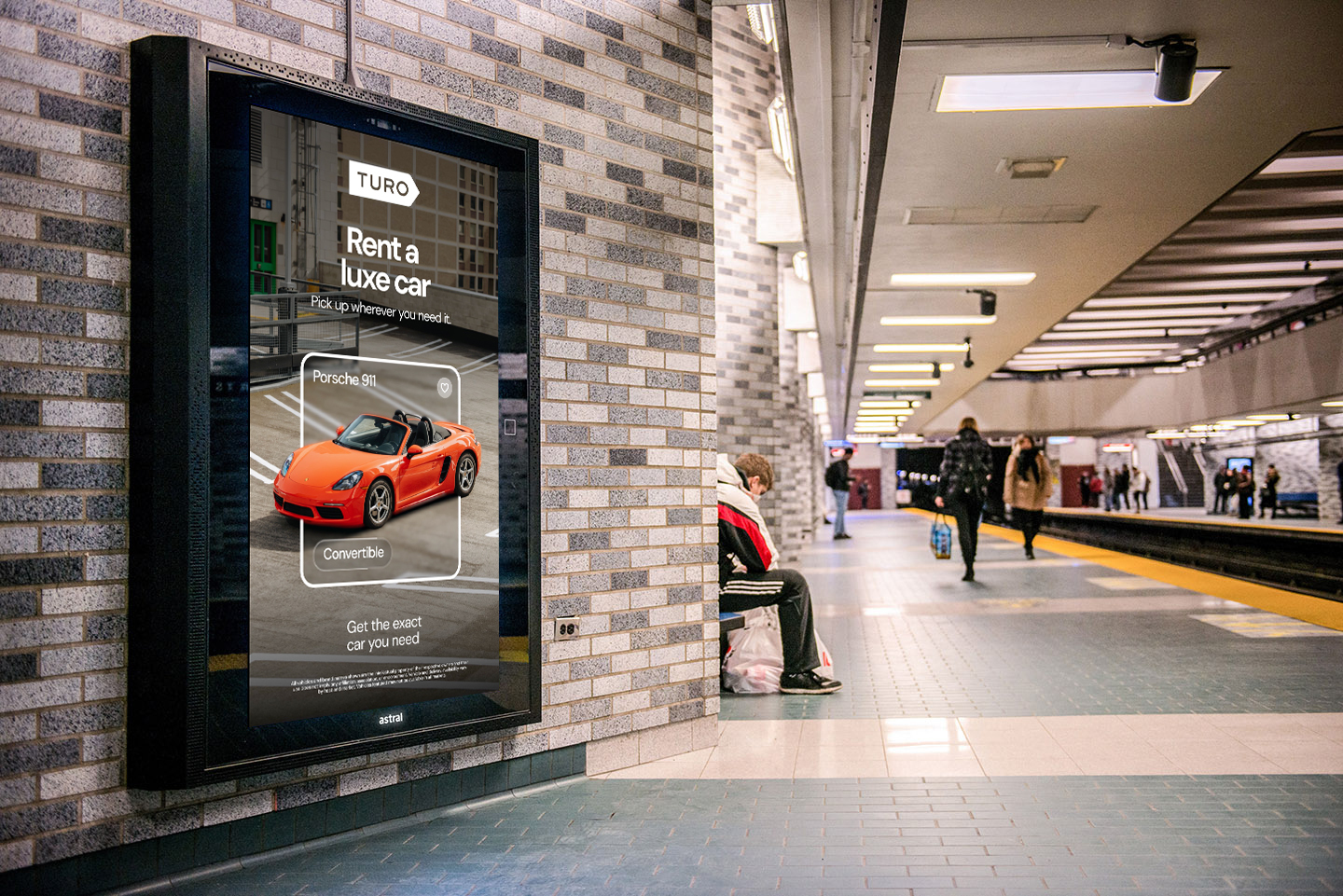 Turo digital out-of-home ad displayed on a subway platform, featuring an orange Porsche and the message “Rent a luxe car.”