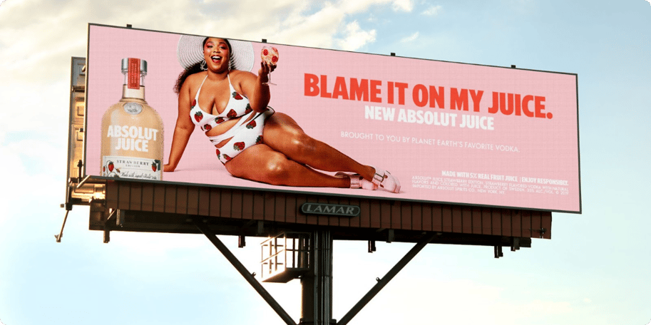 Lizzo digital out-of-home advertising (DOOH) on a large format screen