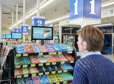 Woman looking at a grocery store ad